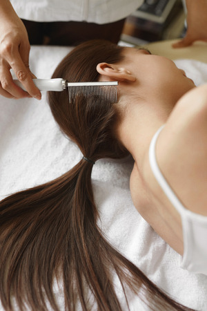Hair Care. Closeup Of Cosmetologist Brushing Woman's Beautiful Healthy Long Hair With Comb For Keratin Supply At Beauty Salon. Hair Treatment With Brush At Cosmetology Center. High Resolution Imageの写真素材