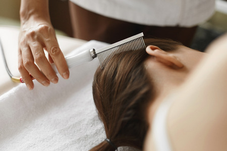 Hair Care. Closeup Of Cosmetologist Brushing Woman's Beautiful Healthy Long Hair With Comb For Keratin Supply At Beauty Salon. Hair Treatment With Brush At Cosmetology Center. High Resolution Imageの写真素材