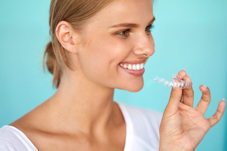 White Smile. Portrait Of Beautiful Smiling Woman With Healthy Straight White Teeth Holding Teeth...
