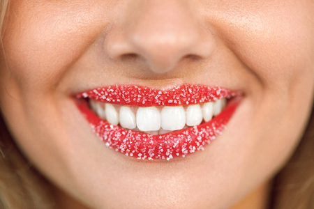 Lip Care. Closeup Of Beautiful Woman's Smile With Healthy White Teeth And Cosmetic Sugar Lip Scrub On. Smiling Girl's Beauty Mouth With Sweet Plump Full Lips. Cosmetics Concept. High Resolution Imageの写真素材