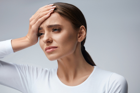 Health Care. Closeup Of Beautiful Young Woman Suffering From Terrible Strong Head Pain, Touching Her Face. Tired, Exhausted Female Feeling Stress And Having Painful Migraine, Headache. High Resolutionの写真素材