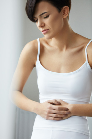 Health Issues. Beautiful Young Woman Feeling Strong Pain In Stomach. Female Suffering From Painful Feeling, Stomach Ache, Abdominal Pain, Having Digestion Problem. Health Care Concept. High Resolutionの写真素材