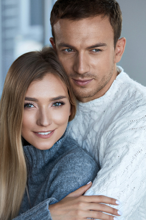 Love And Care. Happy Beautiful Loving Couple Embracing. Portrait Of Handsome Man Hugging Smiling Woman With Fresh Smooth Soft Face Skin, Natural Makeup. Romantic Relationship Concept. High Resolutionの写真素材