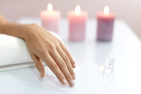 Beautiful Manicure. Closeup Of Woman Hand With Healthy Natural Nails And Soft Skin On White Towel. Female Client Shows Healthy Beautifully Manicured Fingernails In Beauty Salon. High Resolutionの写真素材