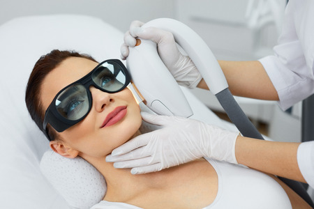 Photorejuvenation. Closeup Of Beautiful Woman Receiving Skin Rejuvenation And Dermabrasion In Beauty Salon. Beautician Doing Facial Skin Resurfacing. Cosmetology. High Resolutionの写真素材