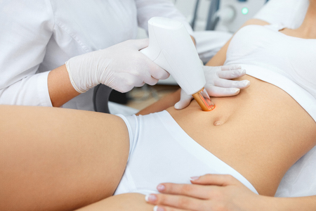 Skin Procedure. Closeup Of Beautician Doing Skin Dermabrasion Using Professional Apparatus. Beautiful Girl Receiving Skin Rejuvenation And Resurfacing In Beauty Salon. Laser Therapy. High Resolutionの写真素材