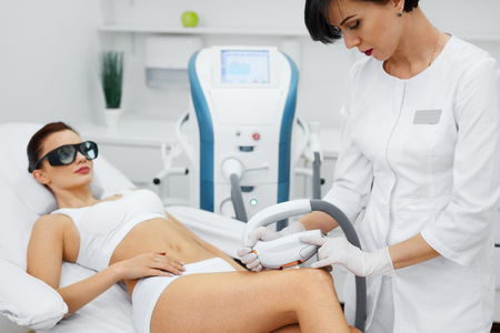Cosmetic Procedure. Beautician Does Skin Resurfacing To Rejuvenate Beautiful Woman Body. Closeup Of Female Body Receiving Skin Dermabrasion. Beauty Treatment. High Resolutionの写真素材