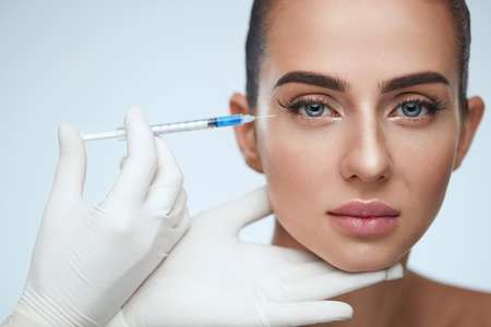 Beauty Care. Portrait Of Beautiful Young Woman Getting Hyaluronic Injection In Face. Closeup Healthy Female With Smooth Skin And Perfect Makeup Receiving Facial Skin Lift Injections. High Resolutionの写真素材