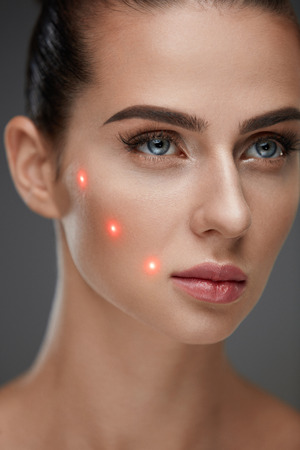 Beauty Treatment. Portrait Of Beautiful Young Woman With Soft Skin And Red Laser Points On Face. Closeup Of Sexy Healthy Woman Before Plastic Surgery On Grey Background. Cosmetology. High Resolutionの写真素材