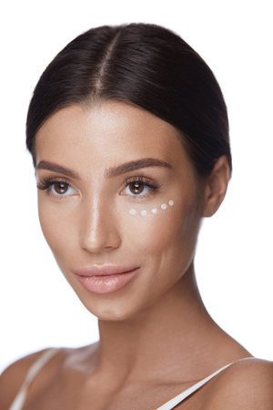 Skin Care. Portrait Of Beautiful Young Female With Soft Smooth Clean Skin And Professional Makeup. Closeup Of Attractive Sexy Girl Using Concealer Under Eyes. Facial Make-up Concept. High Resolutionの写真素材