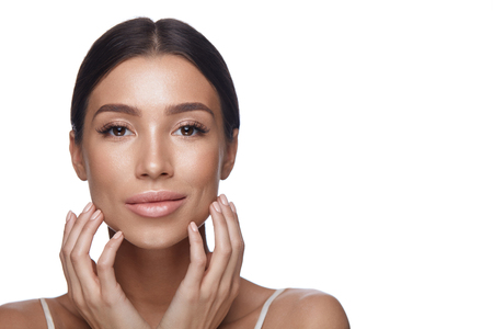 Skin Care. Closeup Of Sexy Young Woman With Clean Pure Facial Skin On White Background. Portrait Beautiful Healthy Female With Fresh Professional Makeup Touching Face. Beauty Concept. High Resolutionの写真素材