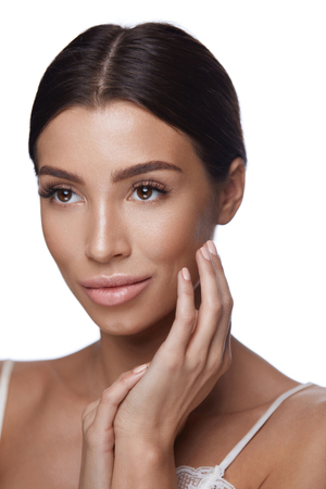 Facial Beauty. Portrait Of Beautiful Young Woman With Both Hands Near Face. Closeup Of Sexy Attractive Female With Smooth Soft Skin And Perfect Fresh Facial Makeup. Cosmetics. High Resolutionの写真素材