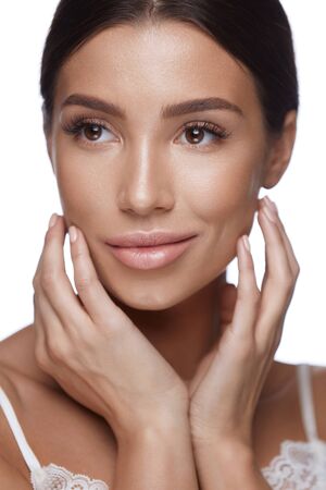 Skin Care. Closeup Of Attractive Sexy Woman Touching Her Face. Portrait Of Beautiful Young Female With Pure Soft Smooth Skin And Perfect Professional Makeup. Facial Beauty. High Resolutionの写真素材