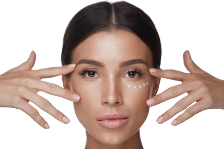 Facial Beauty. Closeup Of Sexy Young Female Face With Fresh Professional Makeup And Corrector Dots Under Eyes. Portrait Of Beautiful Woman With Smooth Soft Skin And Concealer On Skin. High Resolutionの写真素材
