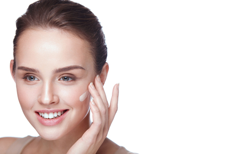 Skin Cosmetics. Portrait Of Beautiful Young Girl Applying Tonal Cream Base On Face. Closeup Of Smiling Woman With Pure Healthy Skin And Perfect Professional Makeup. Facial Beauty. High Resolutionの写真素材