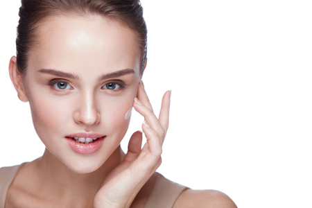 Face Makeup. Closeup Of Beautiful Sexy Woman Hand Applying Foundation On Facial Skin. Portrait Of Attractive Young Female Model With Fresh Makeup And Perfect Skin. Beauty Cosmetics. High Resolutionの写真素材