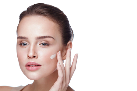 Face Makeup. Closeup Of Beautiful Sexy Woman Hand Applying Foundation On Facial Skin. Portrait Of Attractive Young Female Model With Fresh Makeup And Perfect Skin. Beauty Cosmetics. High Resolutionの写真素材