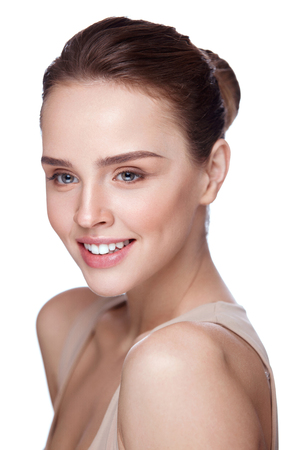 Beauty Face. Beautiful Smiling Girl With Perfect Facial Skin And Professional Makeup. Closeup Of Attractive Young Female Model With Glamourous Make-up On White Background. Cosmetics. High Resolutionの写真素材