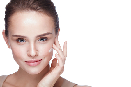 Face Makeup. Closeup Of Beautiful Sexy Woman Hand Applying Foundation On Facial Skin. Portrait Of Attractive Young Female Model With Fresh Makeup And Perfect Skin. Beauty Cosmetics. High Resolutionの写真素材