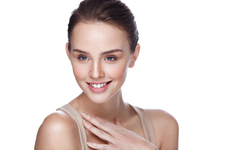 Beauty Cosmetics. Closeup Attractive Young Female Model With Fresh Natural Makeup Touching Her Soft Smooth Pure Skin. Beautiful Smiling Woman Posing On White Background. Skin Care. High Resolutionの写真素材