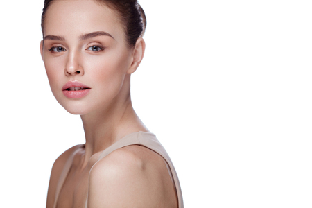 Woman Beauty. Portrait Of Attractive Young Female Model With Smooth Soft Skin And Natural Professional Makeup. Closeup Of Beautiful Girl Face On White Background. Facial Care. High Resolutionの写真素材
