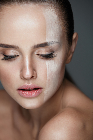 Facial Cosmetics. Closeup Of Foundation Stripe On Young Woman Beautiful Face. Portrait Of Attractive Sexy Woman With Natural Fresh Makeup And Pure Clean Smooth Skin. Beauty Conceptの写真素材