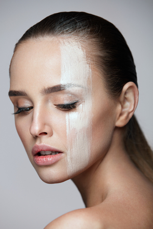 Facial Cosmetics. Closeup Of Foundation Stripe On Young Woman Beautiful Face. Portrait Of Attractive Sexy Woman With Natural Fresh Makeup And Pure Clean Smooth Skin. Beauty Conceptの写真素材