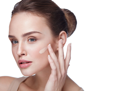 Skin Care. Portrait Of Sexy Beautiful Young Woman Applying Cream Foundation On Facial Skin. Closeup Of Gorgeous Healthy Female Model With Fresh Natural Face Makeup. Beauty Cosmetics. High Resolutionの写真素材