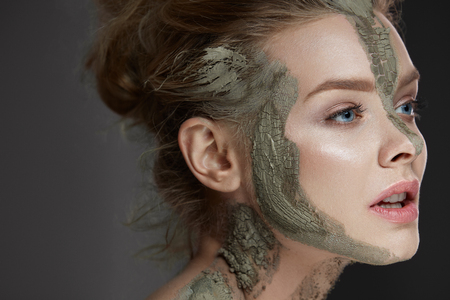Closeup Of Beautiful Young Woman With Cosmetic Clay Mask On Skin.の写真素材