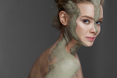 Closeup Of Beautiful Young Woman With Cosmetic Clay Mask On Skin.の写真素材
