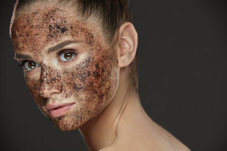 Face Care. Closeup Of Young Woman With Natural Makeup And Coffee Scrub Mask On Fresh Facial Skin. Portrait Of Beautiful Sexy Female Model With Peeling Cosmetic Product On Beauty Face. High Resolutionの写真素材