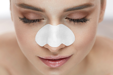 Beautiful Woman Face With Skin Care Patch On Nose. Portrait Of Young Female With Cleansing Pore Strip On Fresh Clean Skin. Closeup Of Sexy Girl With Natural Makeup And Beauty Product. High Resolutionの写真素材