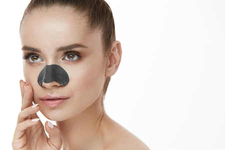 Beautiful Woman With Beauty Face And Skin Care Patch On Nose. Closeup Of Sexy Girl Using Cleansing Strip For Nose. Young Female With Clean Skin, Fresh Makeup On White Background. High Resolutionの写真素材