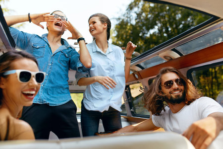 Happy Friends Travel On Summer Vacation, Having Fun In Car. Smiling Young Men And Beautiful Women...
