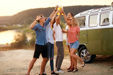 People Drinking. Happy Friends Having Fun Enjoying Party In Nature. Group Of Young People Cheering...