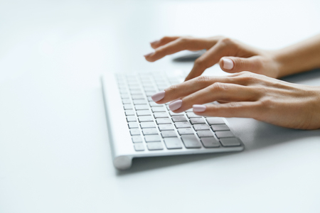 Keyboard And Hands. Close Up Hands Working On Computer. Beautiful Female Fingers Typing On White Keyboard At Workplace. Work. High Quality Imageの写真素材