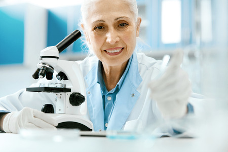 Scientific Laboratory. Scientist Working In Lab, Doing Research At Table. Portrait Of Mature Woman Working With Microscope And Laboratory Glassware At Workplace. Science And Medicine. High Resolutionの写真素材