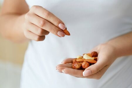 Close Up Of Nuts In Woman Hands.の写真素材