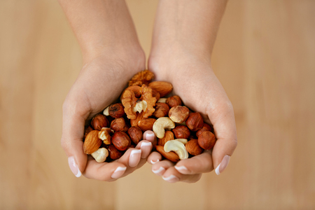 Nuts Heart. Hands Holding Different Nutsの写真素材