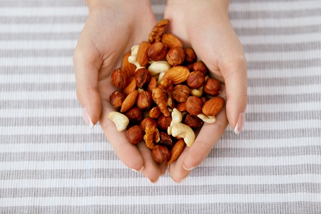 Nuts In Hands. Woman Hands Holding Healthy Foodの写真素材