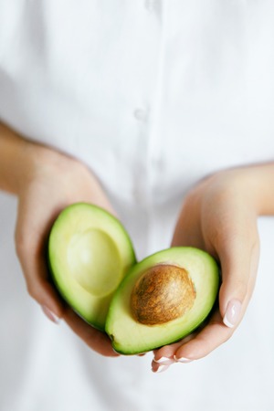 Healthy Food. Avocado In Woman Handsの写真素材