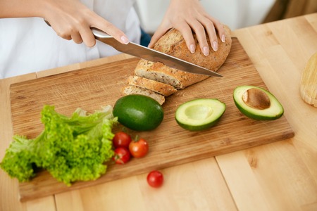 Nutrition And Diet. Close Up Of Woman Hands Cutting Products.の写真素材