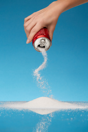 Sugar In Drinks. Hand Holding Soda Can With Sugar. Close Up Of White Sugar Pouring Out Sugar Of Beverage Can. Unhealthy Food Concept. High Quality Image.の写真素材