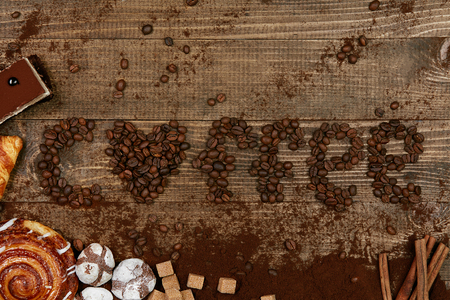 Coffee Word With Heart Of Coffee Beans. Close Up Of Different Sweets And Coffee Beans On Wooden Table. Top View. High Resolution.の写真素材
