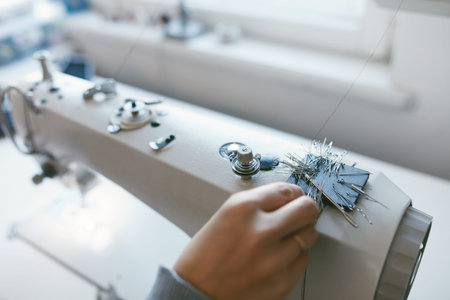 Close Up Of Female Working On Sewing Machine. Tailor Hands Taking Needles And Pins From Magnet On...