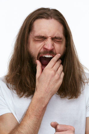 Young Tired Man Yawning, Feeling Sleepy On White Background. High Resolution.