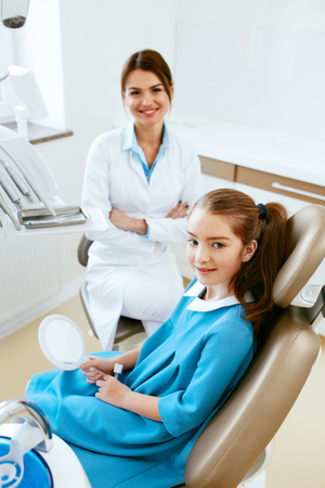 Dentistry. Female Dentist Doctor And Little Patient In Light Dental Clinic. High Resolution.の写真素材