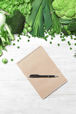 Shopping List. Green Vegetables And Notebook With Pen On White Table. High Resolution.の写真素材