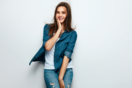 Young Happy Woman In Casual Clothes Having Fun On White Background. High Resolution.の写真素材