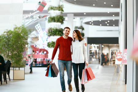 Couple Shopping. Happy Man And Beautiful Smiling Woman With Colorful Bags In Mall. High Resolution.の写真素材